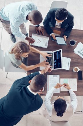 istockphoto-1450388655-612×612 Planning, project management and marketing with business people in meeting for research, strategy and goals with laptop. Growth, analytics and collaboration with employees in corporate office